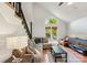 Cozy living room with high ceiling, stairs and a view of the well-manicured front yard at 6005 Lanai Ln, Tega Cay, SC 29708