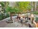 Outdoor stone fireplace and patio area with table and chairs for outdoor living at 6005 Lanai Ln, Tega Cay, SC 29708