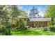 The back of the home has a lovely yard and patio area and mature trees at 6921 Thermal Rd, Charlotte, NC 28211