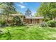 Landscaped backyard featuring lush green grass and mature trees at 6921 Thermal Rd, Charlotte, NC 28211