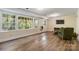 Basement living area with a large window, door to the yard, and wood floors at 6921 Thermal Rd, Charlotte, NC 28211