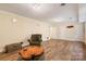 Finished basement area with an armchair, hardwood style floors, neutral paint, and recessed lighting at 6921 Thermal Rd, Charlotte, NC 28211