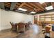 Finished basement area with wood floors, drop ceiling and a wicker table and chair set at 6921 Thermal Rd, Charlotte, NC 28211