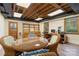Finished basement with a dining area, office space, and natural wood floors at 6921 Thermal Rd, Charlotte, NC 28211