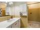 Clean, vintage bathroom with tiled shower and vanity at 6921 Thermal Rd, Charlotte, NC 28211