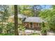 A charming exterior with brick and siding, set amidst lush greenery, offering a serene and private setting at 6921 Thermal Rd, Charlotte, NC 28211
