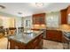 Charming kitchen with wood cabinets, granite counters, and stainless steel appliances at 6921 Thermal Rd, Charlotte, NC 28211