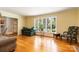 Sunlit living area with large windows, hardwood floors, and comfortable seating at 6921 Thermal Rd, Charlotte, NC 28211