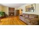Cozy living room with a brick fireplace, hardwood floors and warm lighting at 6921 Thermal Rd, Charlotte, NC 28211