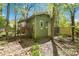 Exterior view of shed with green siding and well-maintained yard at 6921 Thermal Rd, Charlotte, NC 28211