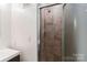 Close up of tile shower with glass door and shower head at 6921 Thermal Rd, Charlotte, NC 28211