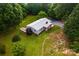 Charming single-story home with a gray roof, complemented by lush greenery and a well-maintained lawn at 7050 Forney Hill Rd, Denver, NC 28037