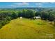 Expansive property featuring a charming home and outbuilding surrounded by lush greenery at 7050 Forney Hill Rd, Denver, NC 28037