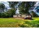 Exterior view of home featuring a well-maintained lawn and a charming deck, perfect for outdoor gatherings at 7050 Forney Hill Rd, Denver, NC 28037