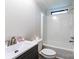 Bright bathroom with shower-tub, modern vanity, white toilet, and small window at 7050 Forney Hill Rd, Denver, NC 28037