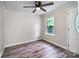 This bedroom features laminate floors, a ceiling fan, and natural light from the window at 7050 Forney Hill Rd, Denver, NC 28037