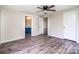 This bedroom features wood laminate flooring, and is situated next to the ensuite bath at 7050 Forney Hill Rd, Denver, NC 28037