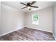 Bedroom with ceiling fan and window overlooking the yard, with light gray vinyl flooring at 7050 Forney Hill Rd, Denver, NC 28037