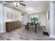 Bright dining room features wood floors, modern lighting, and a window view to the outdoors at 7050 Forney Hill Rd, Denver, NC 28037