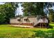 Home exterior boasts a lawn, brick foundation, and stairs up to a deck area at 7050 Forney Hill Rd, Denver, NC 28037