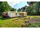 Single-story home with well-maintained front lawn, garden and retaining wall on the side at 7050 Forney Hill Rd, Denver, NC 28037