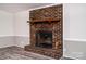 Classic brick fireplace with a wooden mantle, adding warmth and character to the space at 7050 Forney Hill Rd, Denver, NC 28037