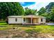 Charming single-story home with brick accents, a well-maintained lawn and an American flag at 7050 Forney Hill Rd, Denver, NC 28037