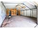 Large garage or workshop featuring concrete floor, plywood walls, and overhead lighting at 7050 Forney Hill Rd, Denver, NC 28037