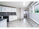 Bright kitchen featuring tiled floors and countertops, complete with a window with shutters at 7050 Forney Hill Rd, Denver, NC 28037