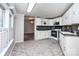 Well-lit kitchen with tile backsplash and white cabinets at 7050 Forney Hill Rd, Denver, NC 28037