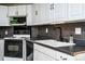 Well-lit kitchen featuring black appliances and white cabinetry at 7050 Forney Hill Rd, Denver, NC 28037