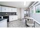 Bright kitchen featuring tile flooring, neutral paint, and dining area at 7050 Forney Hill Rd, Denver, NC 28037