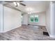 Bright living room features wood floors, modern lighting, and a window view to the outdoors at 7050 Forney Hill Rd, Denver, NC 28037
