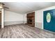 Bright and open living room featuring a brick fireplace and blue front door at 7050 Forney Hill Rd, Denver, NC 28037