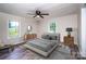 This main bedroom features a neutral color palette, multiple windows and wood laminate flooring at 7050 Forney Hill Rd, Denver, NC 28037