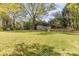 Backyard with storage buildings and mature trees at 706 Lowell Ave, Lowell, NC 28098