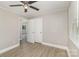 This bedroom offers light walls, trim, and vinyl floors, a ceiling fan, a window, and a closet at 706 Lowell Ave, Lowell, NC 28098