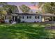 Beautiful home with a well-manicured front lawn and flowering bushes at 706 Lowell Ave, Lowell, NC 28098