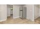 Passageway in the home with grey walls and stainless steel refrigerator in view at 706 Lowell Ave, Lowell, NC 28098