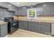 Efficient kitchen with dark cabinets, sleek countertops, and modern appliances at 706 Lowell Ave, Lowell, NC 28098