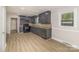 Well-lit kitchen with dark cabinetry, stainless steel appliances, and a functional layout at 706 Lowell Ave, Lowell, NC 28098