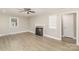 Comfortable living room with fireplace, light wood-look floors, and neutral walls creating a calming atmosphere at 706 Lowell Ave, Lowell, NC 28098