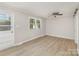 Living room filled with light and vinyl floors, along with fresh paint and a ceiling fan at 706 Lowell Ave, Lowell, NC 28098