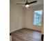 This bedroom features a modern ceiling fan, wood-look flooring, a large window and neutral paint at 833 Arlington Ave, Rock Hill, SC 29730