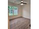 Neutral bedroom features wood-look flooring, a ceiling fan, and a large window at 833 Arlington Ave, Rock Hill, SC 29730