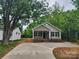 Charming single story home with a concrete driveway and a cozy covered porch at 833 Arlington Ave, Rock Hill, SC 29730