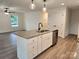 New kitchen with island with seating, stainless appliances and open floorplan at 833 Arlington Ave, Rock Hill, SC 29730