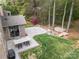 A backyard includes a stone paver patio, a lawn, and a wooded area with steps at 9069 Blue Ridge Dr, Indian Land, SC 29707