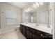 Bathroom with double sink vanity and large mirror at 9069 Blue Ridge Dr, Indian Land, SC 29707