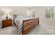 Cozy bedroom with a classic wood frame bed, soft carpet, and calming natural light at 9069 Blue Ridge Dr, Indian Land, SC 29707